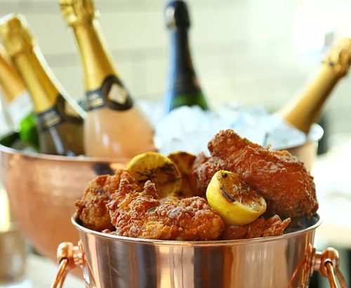 Copper buckets with champagne and fried chicken